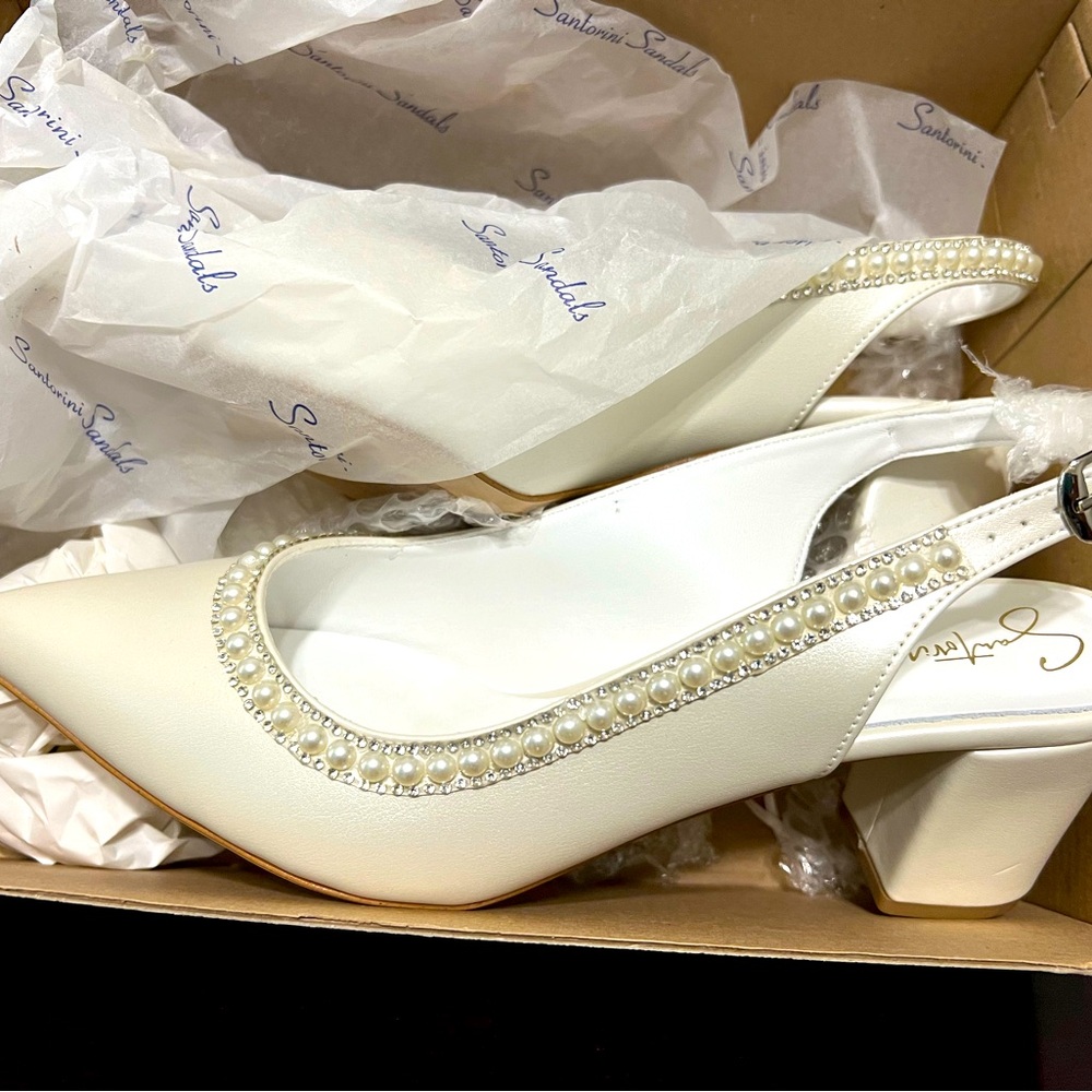 White leather pumps. Purchased for a wedding; however, I never used them. New